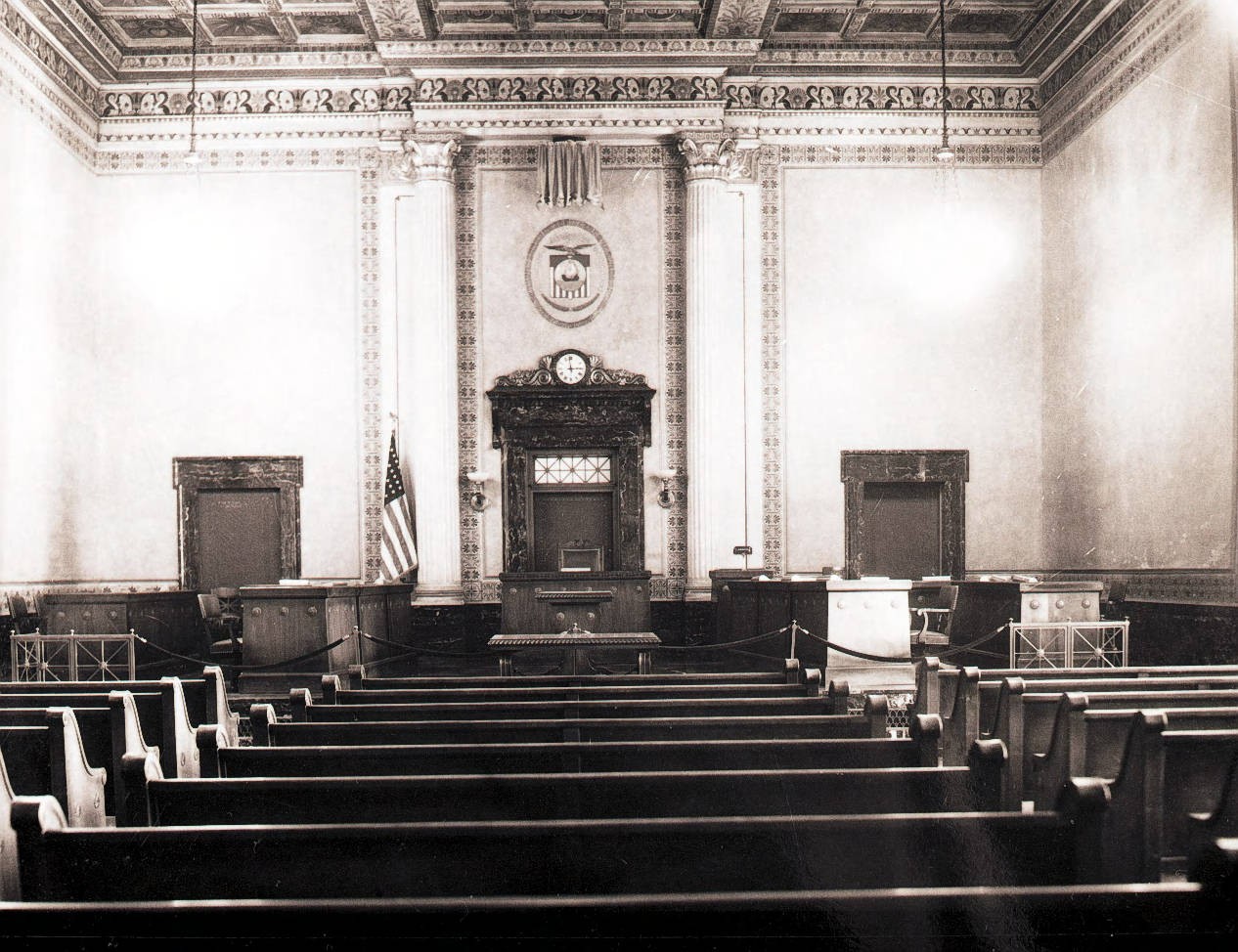 Archival black and white view down the center aisle of Columbus City Council chambers toward the elevated dais and rostrum.