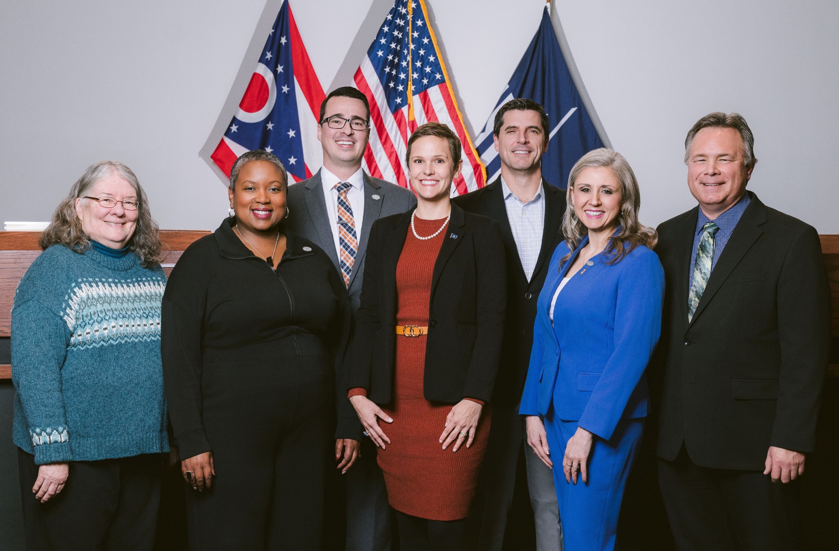 Seven members of the Gahanna City Council standing together in Council Chambers.