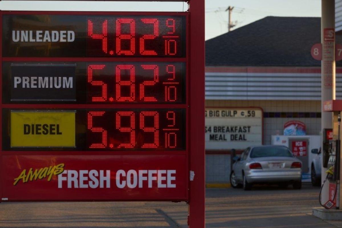 Digital gas station price board showing unleaded gas at $4.82 and diesel at $5.99 per gallon.