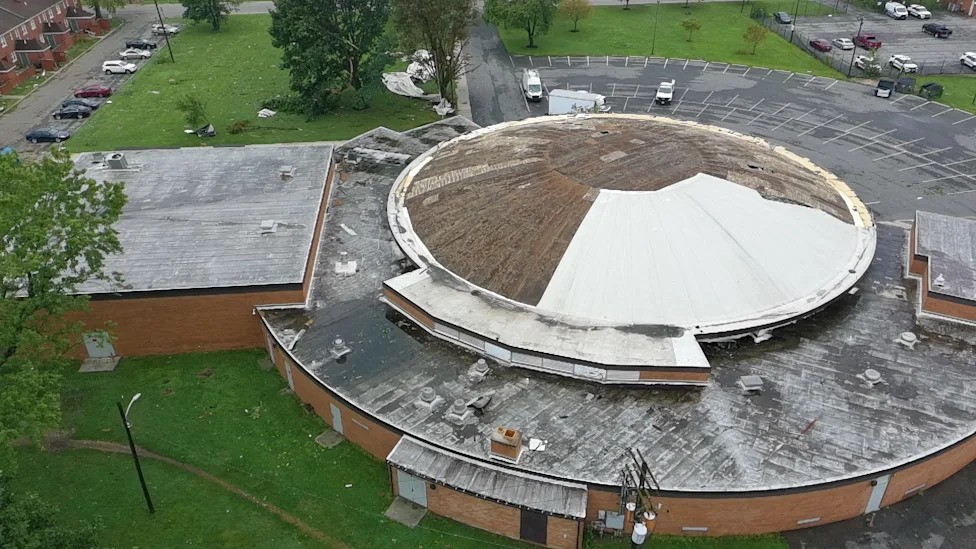 Aerial view of the Barack Recreation Center roof showing extensive storm damage to the circular dome and flat roof surfaces.
