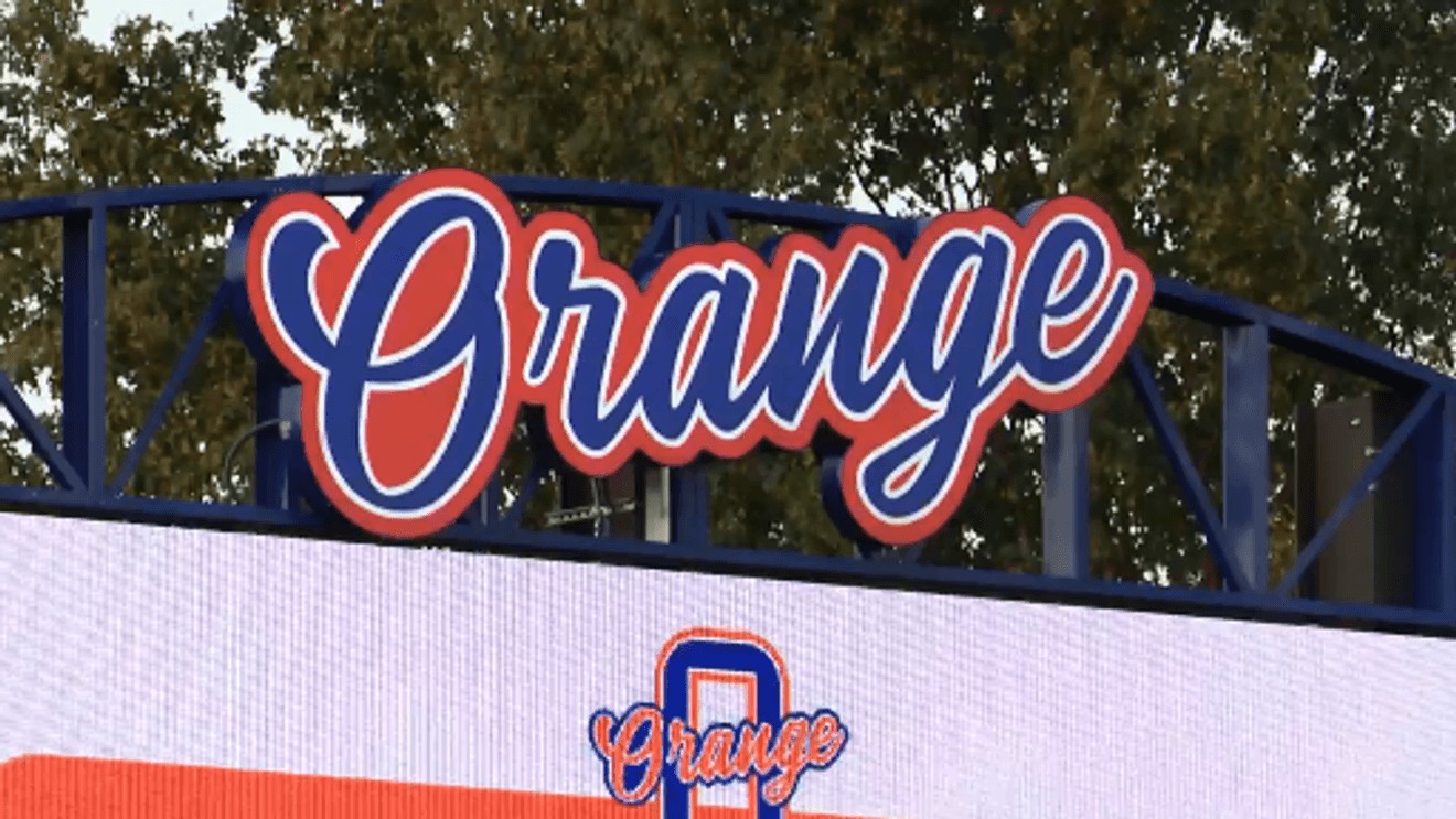Olentangy Orange High School athletic sign displaying the word 'Orange' in script above an orange and blue Pioneers logo.