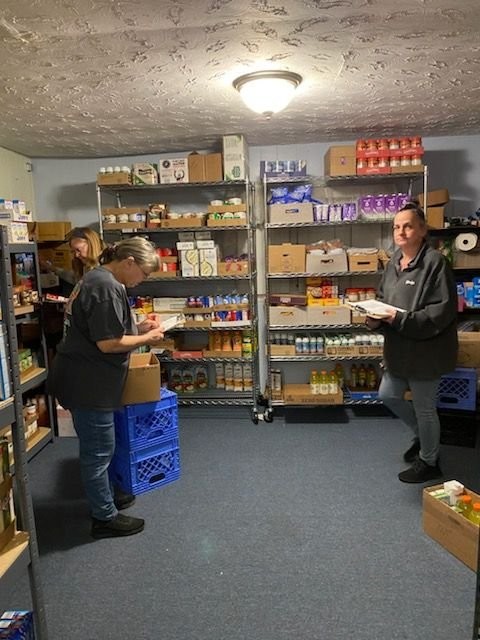 Shelves stocked with canned food and supplies at the Eastside Mission Food Pantry.