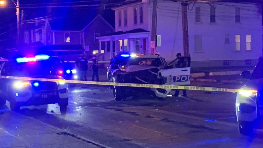 Front view of a heavily damaged Columbus Division of Police cruiser cordoned off by yellow police tape at a Franklinton crash scene.