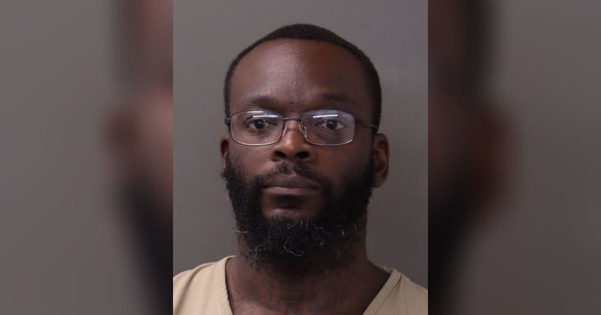 Franklin County Jail booking photograph of Shamieke Pugh wearing rectangular eyeglasses, a beard, and a beige inmate shirt against a plain wall.